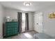 Bright bedroom featuring a blue dresser, window, and carpet flooring at 154 Jared Dr, Fuquay Varina, NC 27526