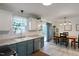 Bright kitchen with stainless appliances, granite countertops, white cabinetry, and access to back deck at 154 Jared Dr, Fuquay Varina, NC 27526