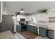 Well-lit kitchen features granite countertops, stainless appliances, and stylish white and gray cabinets at 154 Jared Dr, Fuquay Varina, NC 27526