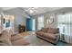 This living room boasts bright light, a blue door, and two sofas at 154 Jared Dr, Fuquay Varina, NC 27526