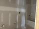 Unfinished bathroom with a new tub and shower combo, plus prepared plumbing for fixtures at 1613 Malcus Ct # 68, Fuquay Varina, NC 27526
