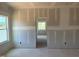 View of an unfinished bedroom interior with two windows and closet at 1613 Malcus Ct # 68, Fuquay Varina, NC 27526