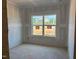 Unfinished bedroom with a large window, showing a neighboring home at 1613 Malcus Ct # 68, Fuquay Varina, NC 27526