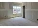 An unfinished bedroom with a bright window offering neighborhood views and an open doorway at 1613 Malcus Ct # 68, Fuquay Varina, NC 27526