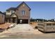 New construction brick home featuring an open two-car garage and craftsman architectural details at 1613 Malcus Ct # 68, Fuquay Varina, NC 27526