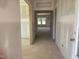 Unfinished hallway with neutral walls, leading to a room with view of backyard at 1613 Malcus Ct # 68, Fuquay Varina, NC 27526