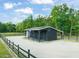 The property includes a well-kept barn, with a gravel drive and black fencing at 1717 Ormond Rd, Hurdle Mills, NC 27541