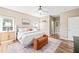Inviting bedroom with a large bed, bench, ceiling fan, and hardwood floors at 1717 Ormond Rd, Hurdle Mills, NC 27541