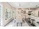 Sunny dining area with a table, chairs, chandelier, and access to the kitchen and deck at 1717 Ormond Rd, Hurdle Mills, NC 27541