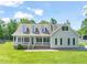 Inviting home with a charming front porch, manicured lawn, and beautiful curb appeal at 1717 Ormond Rd, Hurdle Mills, NC 27541