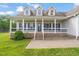 Charming home with a welcoming front porch, brick accents, and well-manicured landscaping at 1717 Ormond Rd, Hurdle Mills, NC 27541