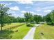 Well-maintained grounds include graveled driveway and lush green pastures at 1717 Ormond Rd, Hurdle Mills, NC 27541