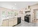 Bright kitchen boasts a center island with white countertop, sink, and black dishwasher and range at 1717 Ormond Rd, Hurdle Mills, NC 27541