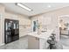 Modern kitchen features white cabinetry, a center island with barstool seating, and stainless-steel appliances at 1717 Ormond Rd, Hurdle Mills, NC 27541