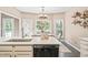 Bright kitchen with stainless steel dishwasher, quartz countertops, and breakfast area overlooking the yard at 1717 Ormond Rd, Hurdle Mills, NC 27541