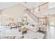 Open-concept living room with high ceilings, staircase, and seamless flow to the dining area at 1717 Ormond Rd, Hurdle Mills, NC 27541