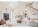 Bright living room features a fireplace, comfortable seating, and views into the dining area and kitchen at 1717 Ormond Rd, Hurdle Mills, NC 27541