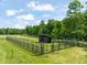 The property boasts a well-maintained paddock area with shelter, ideal for horses or livestock at 1717 Ormond Rd, Hurdle Mills, NC 27541