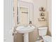 Chic powder room with pedestal sink, stylish mirror, and decorative shelves at 1717 Ormond Rd, Hurdle Mills, NC 27541