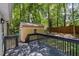 View of the back deck and storage shed, surrounded by lush greenery and mature trees at 2007 Eastwood Dr, Durham, NC 27703