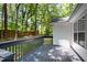 Spacious back deck offering a view of the wooded backyard with mature trees at 2007 Eastwood Dr, Durham, NC 27703