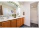Bathroom featuring double sinks with oak cabinetry, a large mirror, and a shower-tub combo at 2007 Eastwood Dr, Durham, NC 27703
