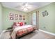 Bright bedroom with colorful accents, including a red throw pillow and framed floral prints at 2007 Eastwood Dr, Durham, NC 27703