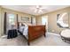 Cozy bedroom featuring a wood sleigh bed, neutral walls, and a ceiling fan at 2007 Eastwood Dr, Durham, NC 27703