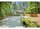 Quaint home with a long driveway and fenced in yard, surrounded by lush trees at 2007 Eastwood Dr, Durham, NC 27703