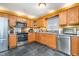 Kitchen featuring stainless steel appliances, custom cabinets, and black tile floors at 2007 Eastwood Dr, Durham, NC 27703