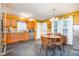 Eat in kitchen with yellow walls, black tile flooring, and modern light fixture at 2007 Eastwood Dr, Durham, NC 27703