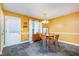 Eat in kitchen with yellow walls, black tile flooring, and modern light fixture at 2007 Eastwood Dr, Durham, NC 27703