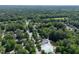 Expansive aerial view of a neighborhood with a community pool surrounded by mature trees and lush landscaping at 203 Halls Mill Dr, Cary, NC 27519