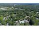 Aerial view of a residential area featuring a pool, lush trees, and winding roads at 203 Halls Mill Dr, Cary, NC 27519