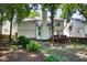 Landscaped backyard with mature trees and view of the home's back facade and deck at 203 Halls Mill Dr, Cary, NC 27519