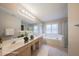 Well-lit bathroom with double vanity, soaking tub, walk-in shower, and modern fixtures at 203 Halls Mill Dr, Cary, NC 27519