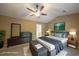 Staged bedroom with ceiling fan, neutral walls, and furnished with a gray bedset at 203 Halls Mill Dr, Cary, NC 27519