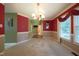Well-appointed dining room with stylish wainscoting, neutral carpeting, and a statement chandelier for lighting at 203 Halls Mill Dr, Cary, NC 27519