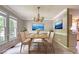 Formal dining room is decorated with wainscoting, crown molding, and a stylish chandelier at 203 Halls Mill Dr, Cary, NC 27519