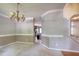 Elegant dining area with chandelier and views to the kitchen at 203 Halls Mill Dr, Cary, NC 27519