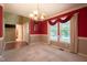 Traditional dining room with carpet, decorative wainscoting, and a chandelier over the dining table at 203 Halls Mill Dr, Cary, NC 27519