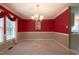 Charming dining area with carpet, a bright window, and a decorative chandelier for an inviting atmosphere at 203 Halls Mill Dr, Cary, NC 27519