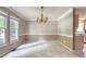 Traditional dining room with neutral paint, chair rail, and large windows for natural light at 203 Halls Mill Dr, Cary, NC 27519
