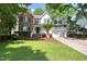 Charming two-story home with a combination of brick and siding, lush lawn, and mature trees at 203 Halls Mill Dr, Cary, NC 27519