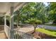 Inviting covered front porch with view of the street and mature trees at 203 Halls Mill Dr, Cary, NC 27519