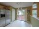 Eat-in kitchen with stainless steel refrigerator and view of outdoor wooden deck at 203 Halls Mill Dr, Cary, NC 27519