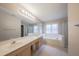 Bright main bathroom with double vanity, large mirror, soaking tub, and separate shower at 203 Halls Mill Dr, Cary, NC 27519