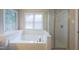 Bright bathroom boasting a soaking tub with jets and separate shower, perfect for relaxation at 203 Halls Mill Dr, Cary, NC 27519