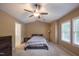 Well-lit main bedroom with large windows, plush carpet, and a ceiling fan at 203 Halls Mill Dr, Cary, NC 27519