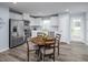 Bright kitchen with white cabinets, modern appliances, and an adjacent dining area with a round table at 222 Rosewood Dr, Sanford, NC 27330